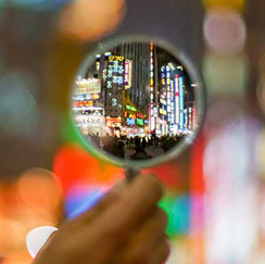 Magnifying glass looking at city