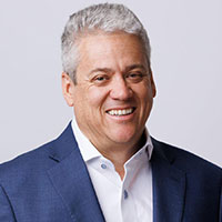 Portrait of a professional man posing with a smile in an office setting.