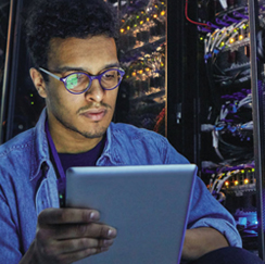 Man with tablet in server room