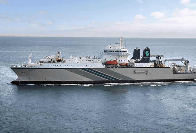 Cable-laying ship at sea, equipped for installing and maintaining subsea fiber optic cables.