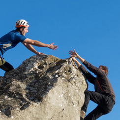 Climbers hands outreached