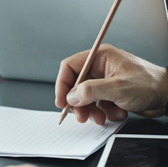 Hand holding a pencil writing