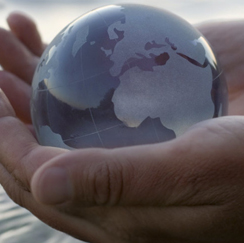 Person holding glass globe 