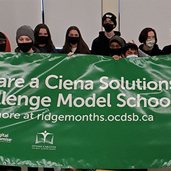 Students holding a Ciena Solutions Challenge banner