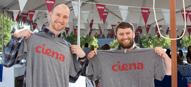 Cyan employees holding Ciena shirts