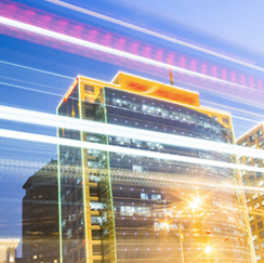 Tall building at night with streaks of light overlaid