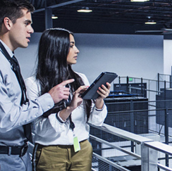 Man and woman with tablets in server room