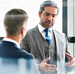 Man in gray suit talking