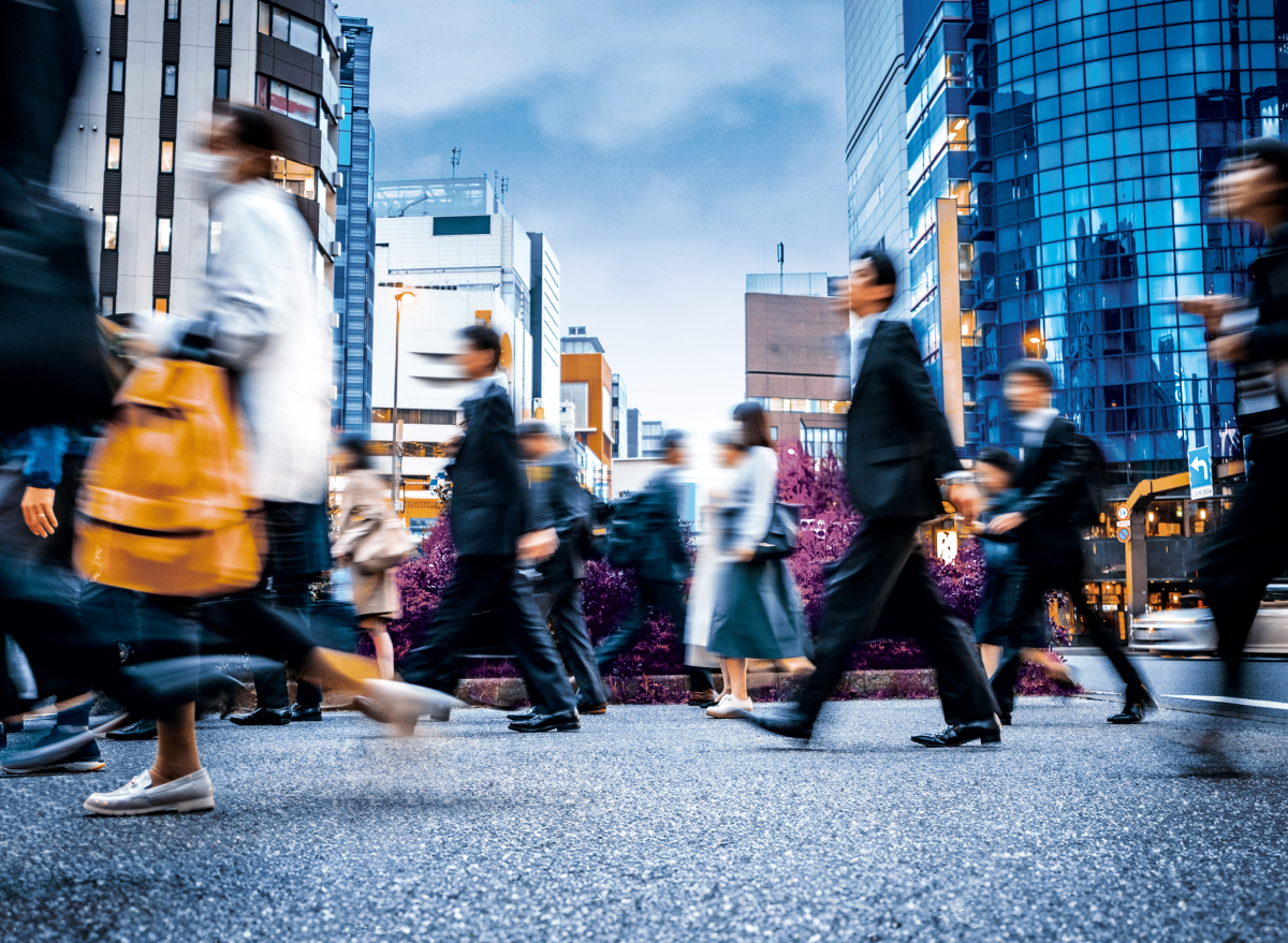 People crossing street in busy metro