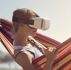 Woman in hammock with virtual reality goggles