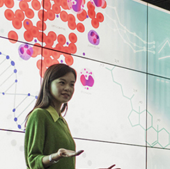 Woman in green in front of screen