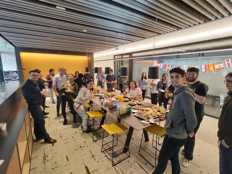 Group of people around a large table, eating and celebrating