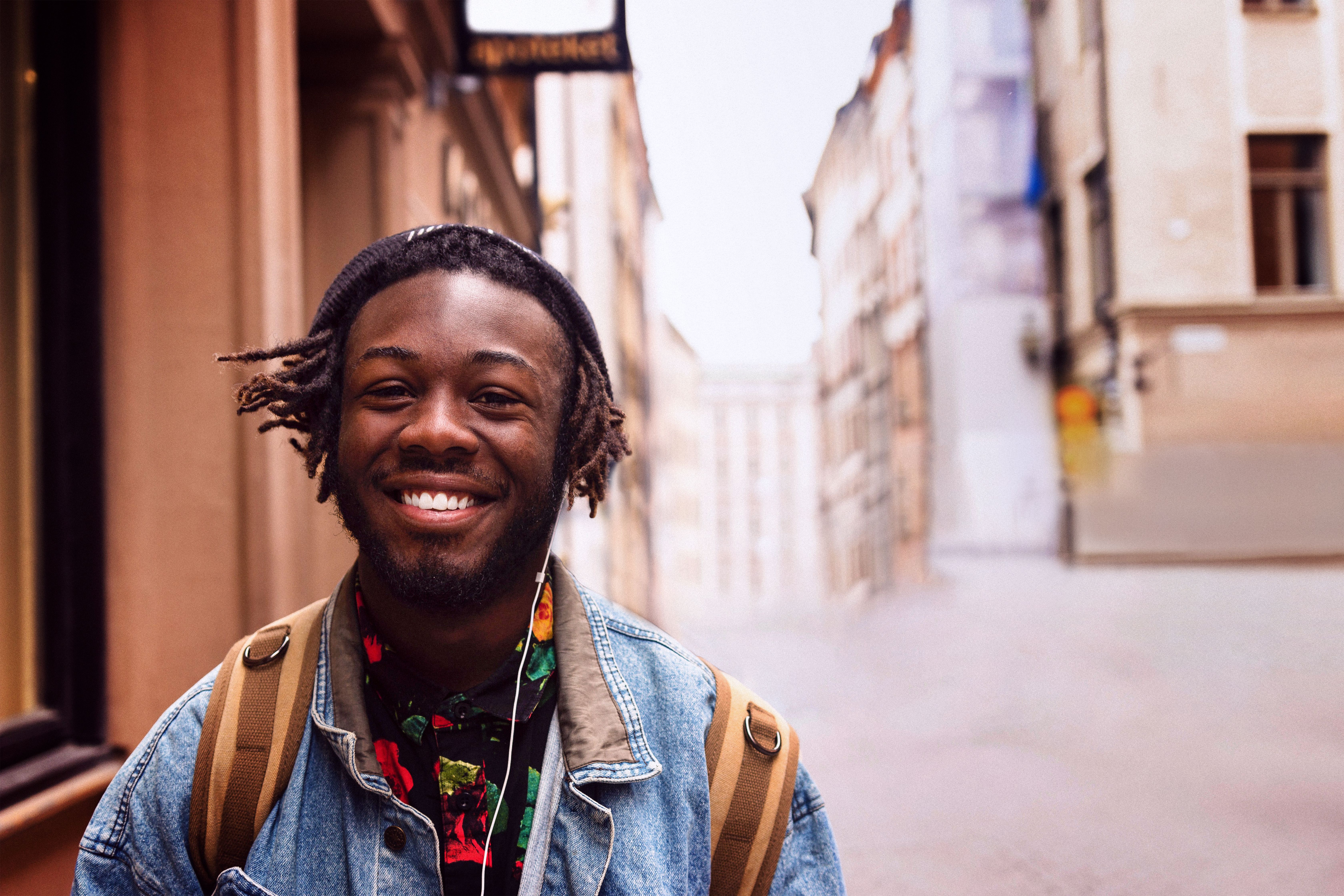 Man in headphones walking down street