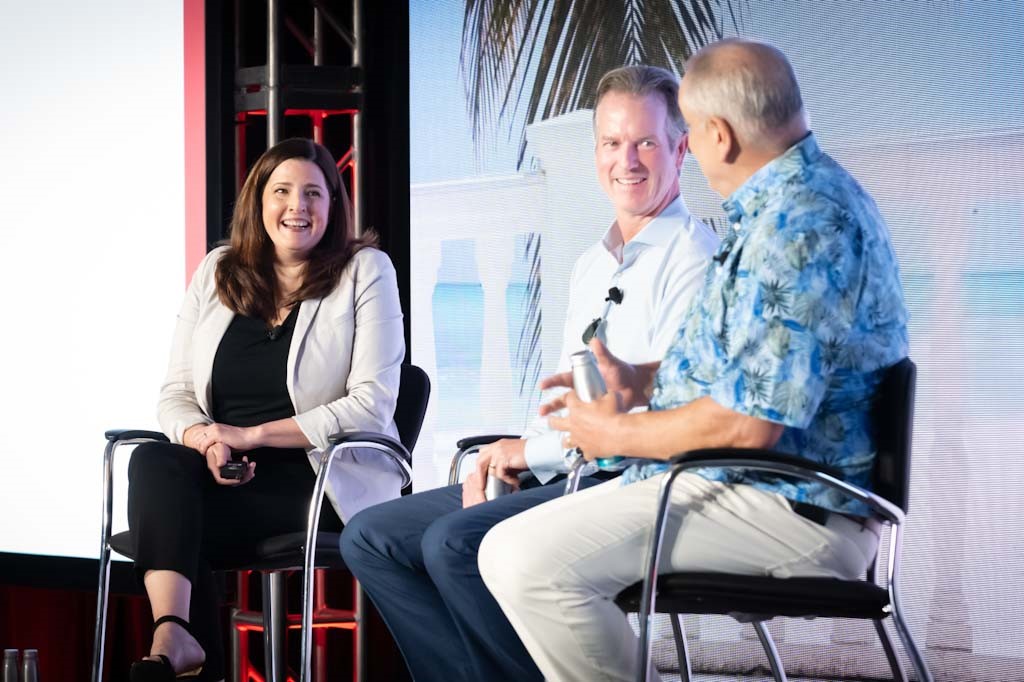 three people sitting on a stage