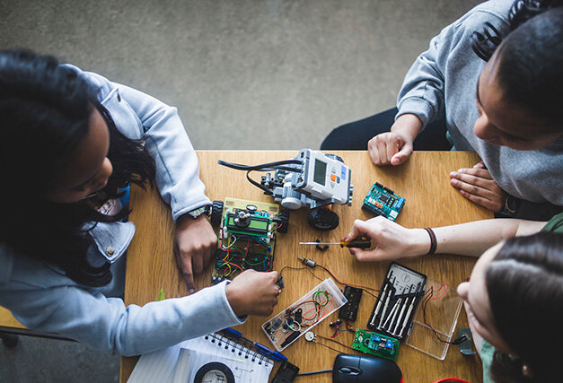 Students playing with robots