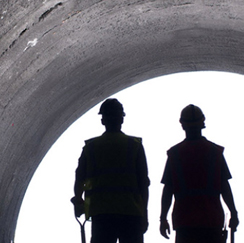 Silhouettes of workers in tunnel
