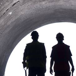 Silhouetted people holding shovels.