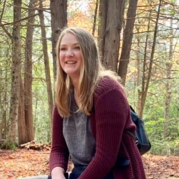 Girls smiling while hiking in the woods 