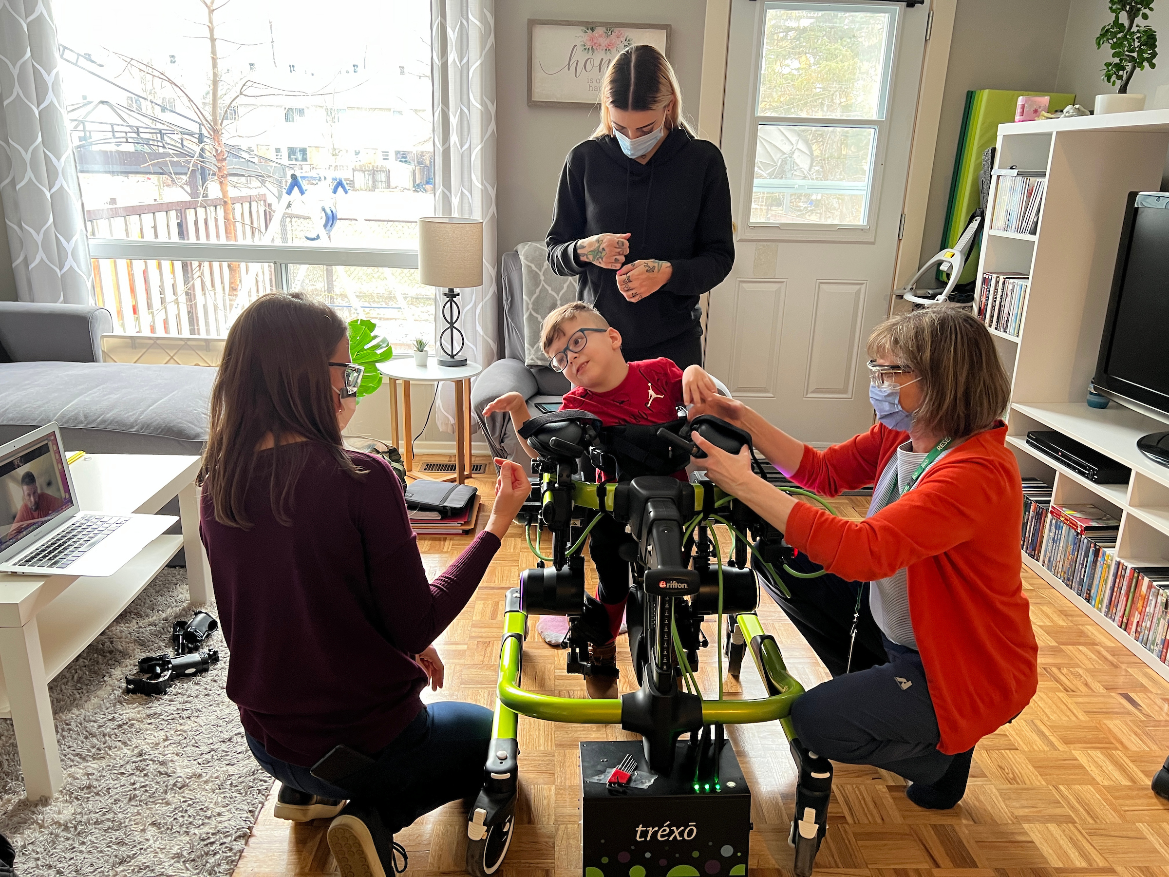 A young patient tries out the robot walker