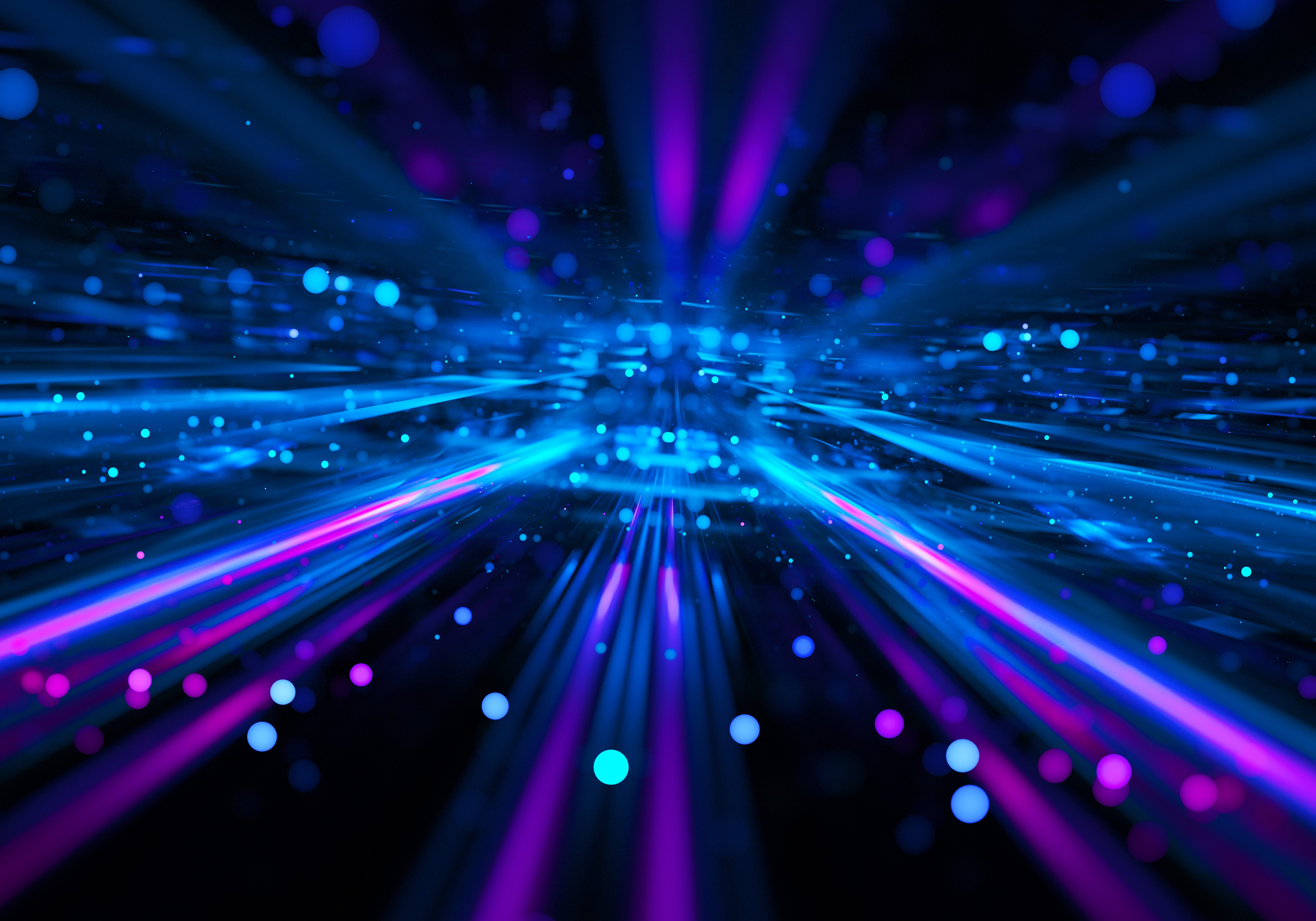 Abstract blue and purple light streaks and particles illustrating high-speed optical data flow and advanced network connectivity.
