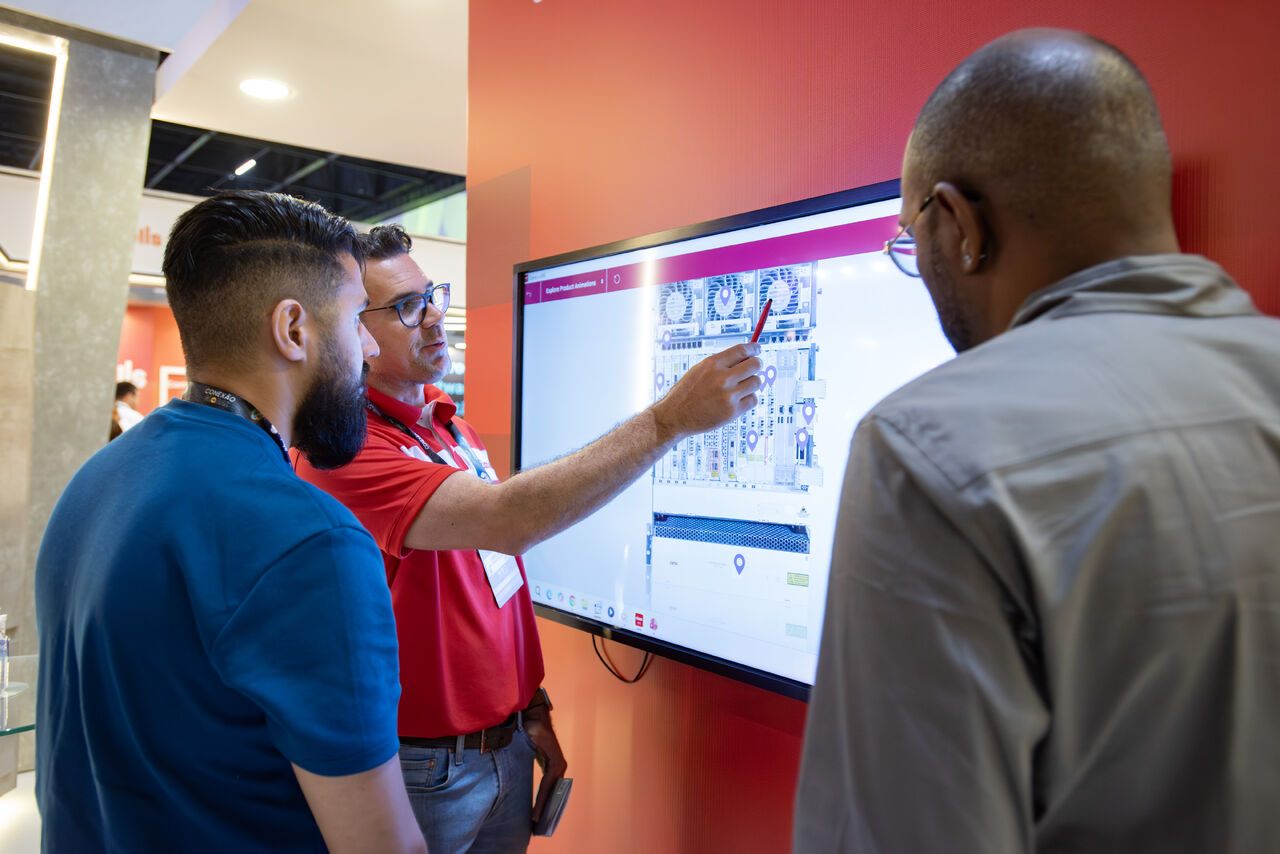 A Ciena representative explaining a visual network-management or equipment-monitoring interface to attendees.
