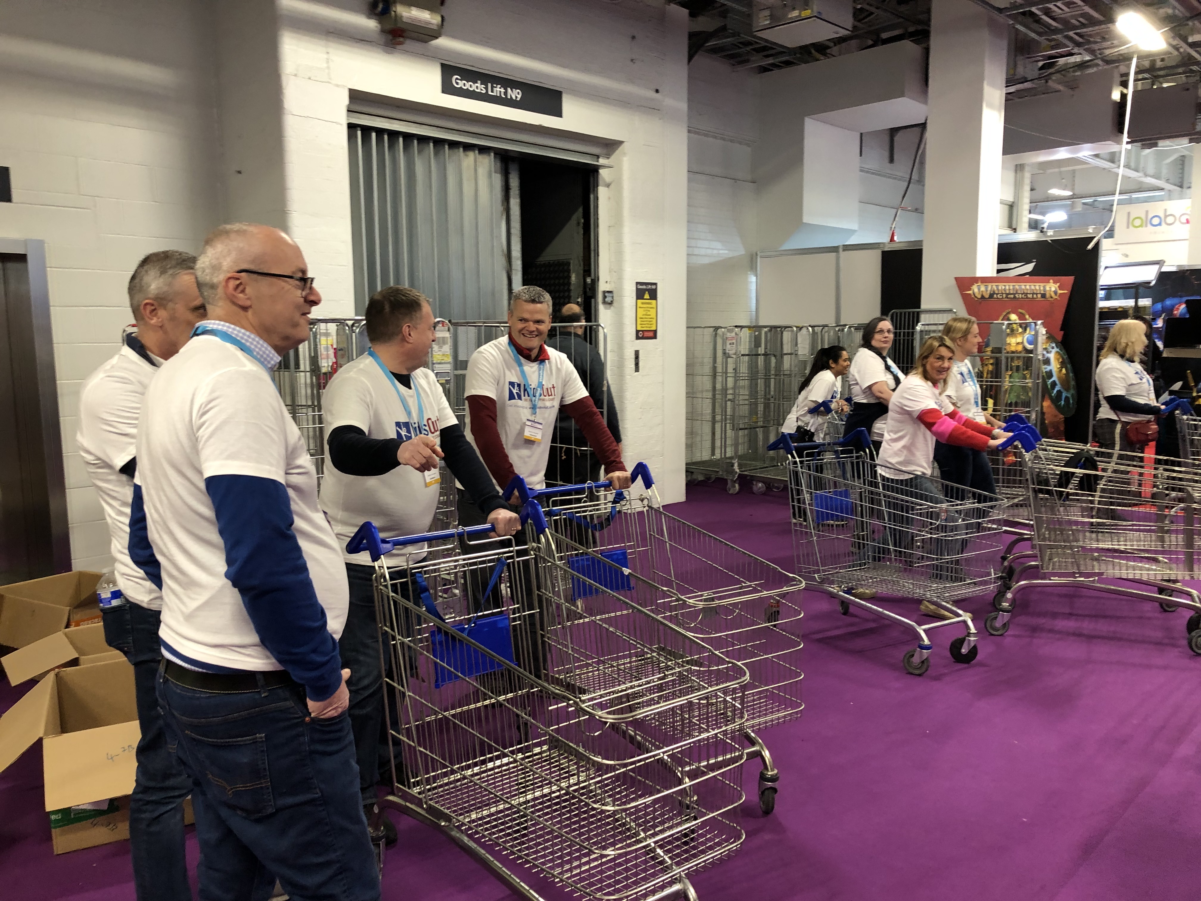 Men and women standing with shopping carts