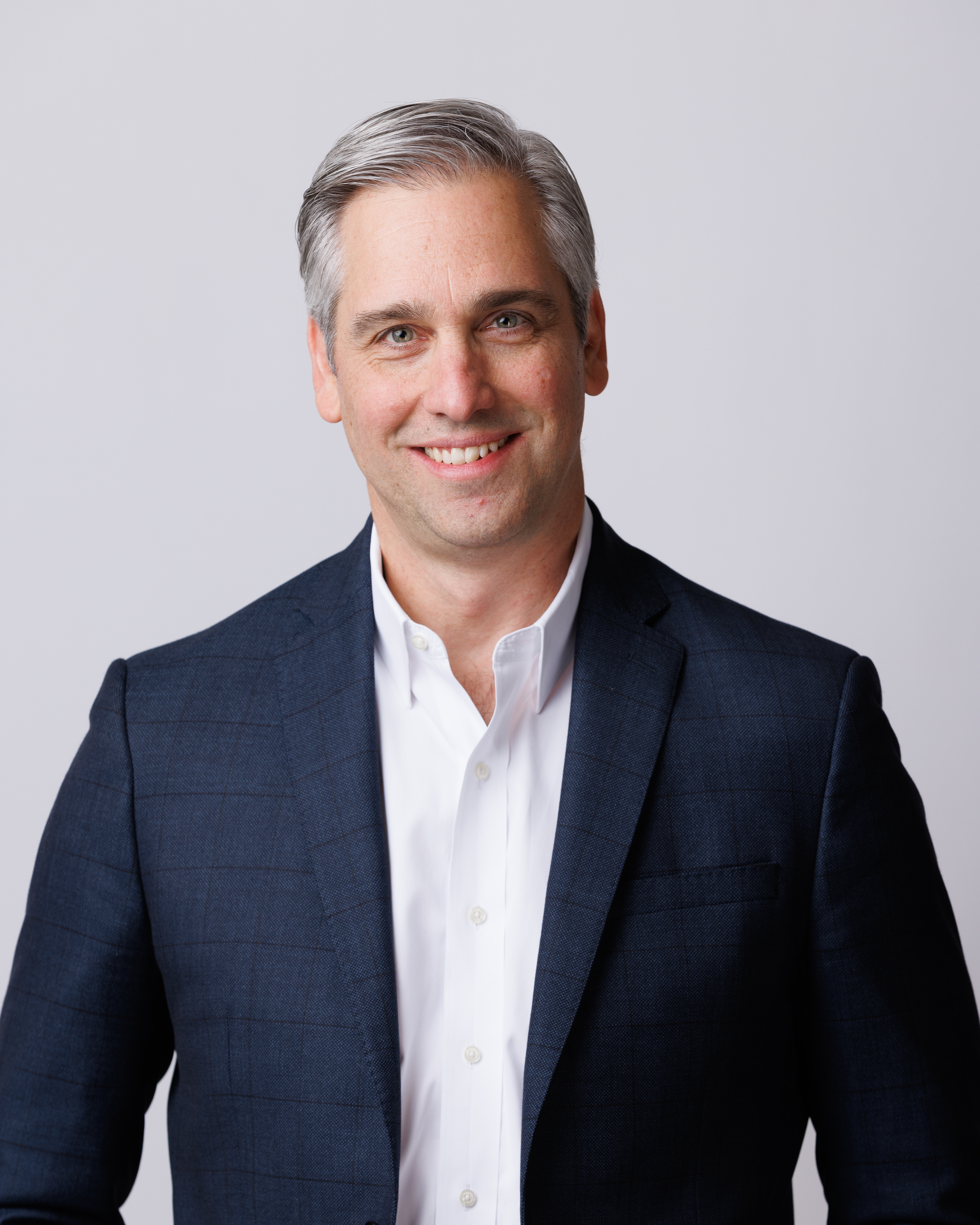 Professional headshot of man smiling