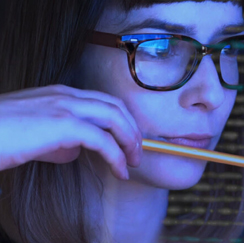 Girl with glasses looking at computer screen