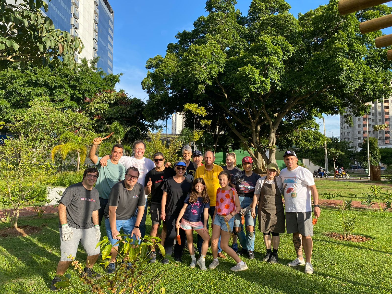 Men and women smiling together outside at a park