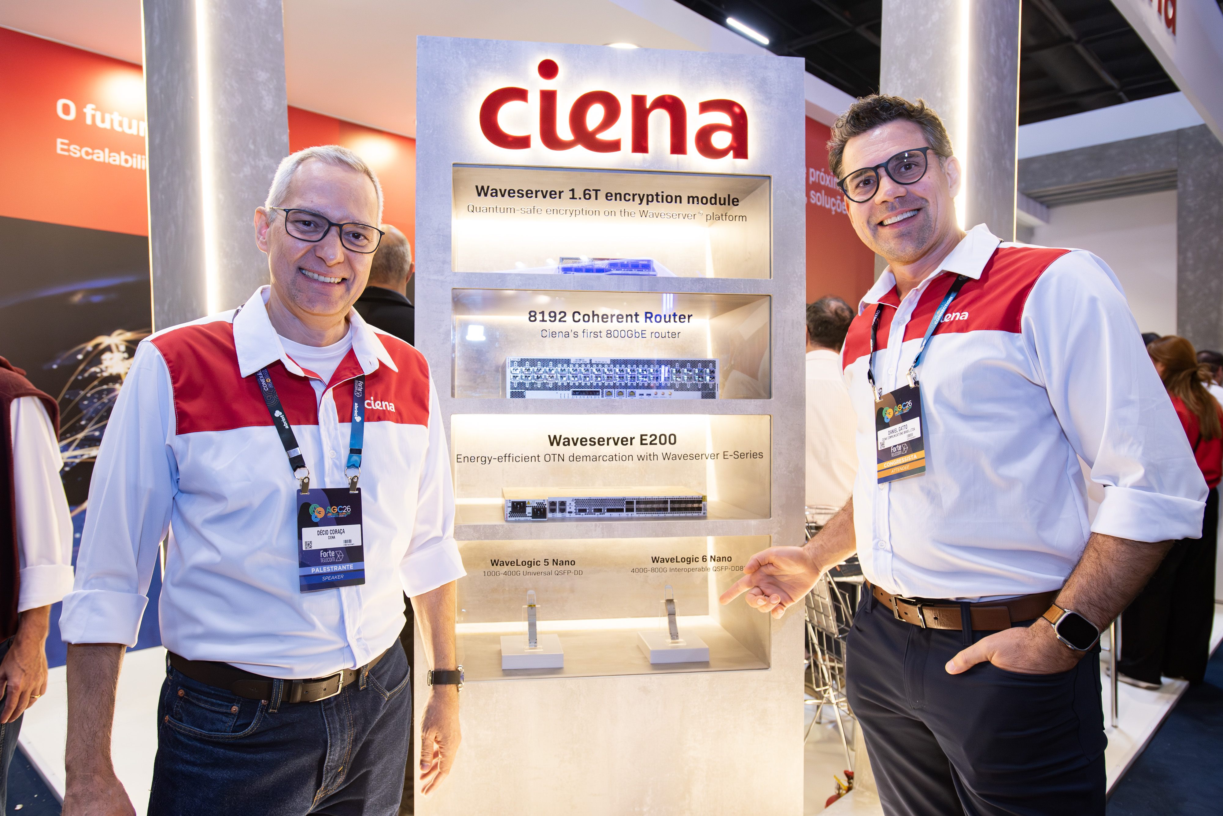 Two representatives standing beside a product display cabinet.