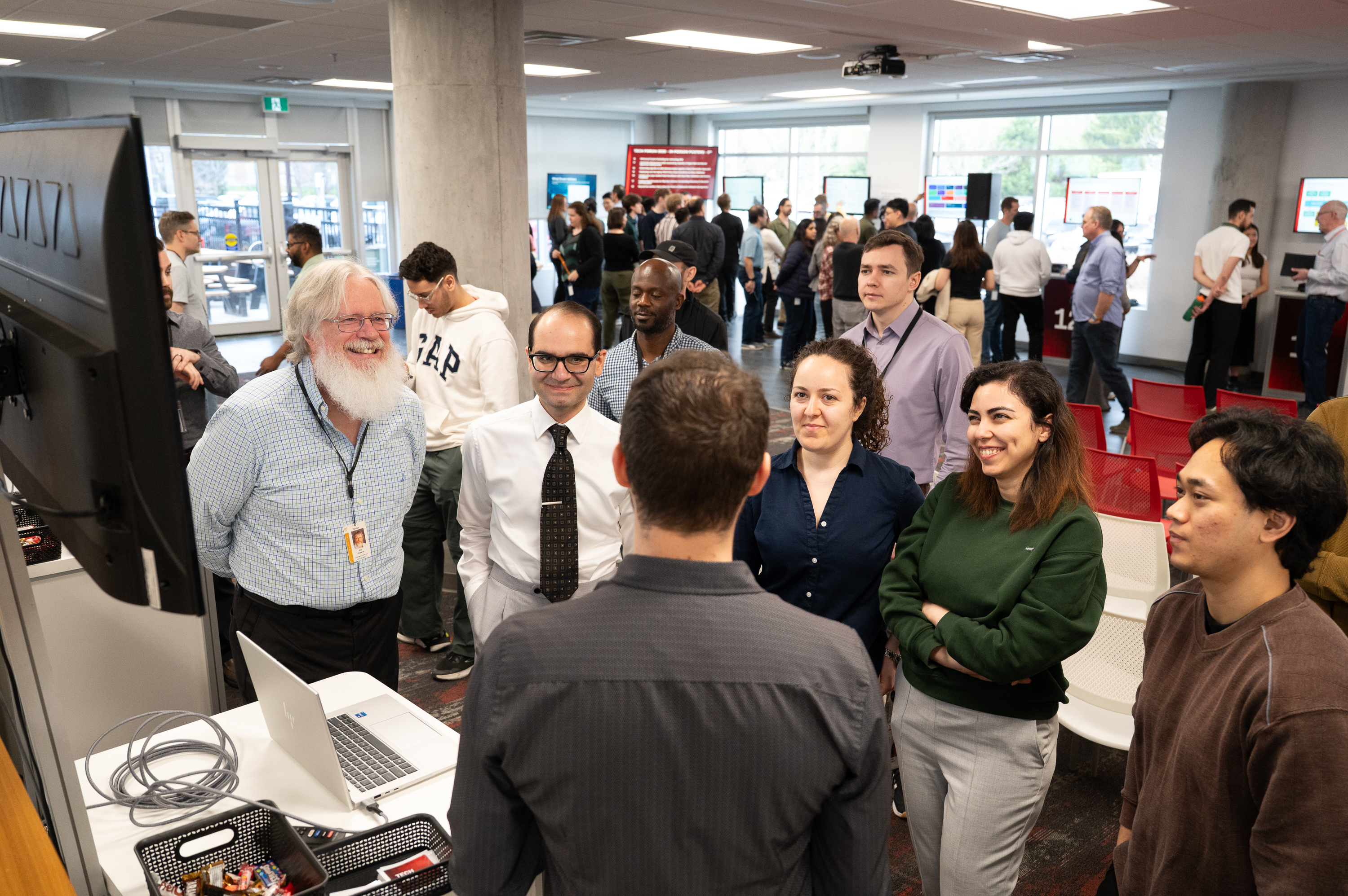 Team members at the poster session in our Ottawa office