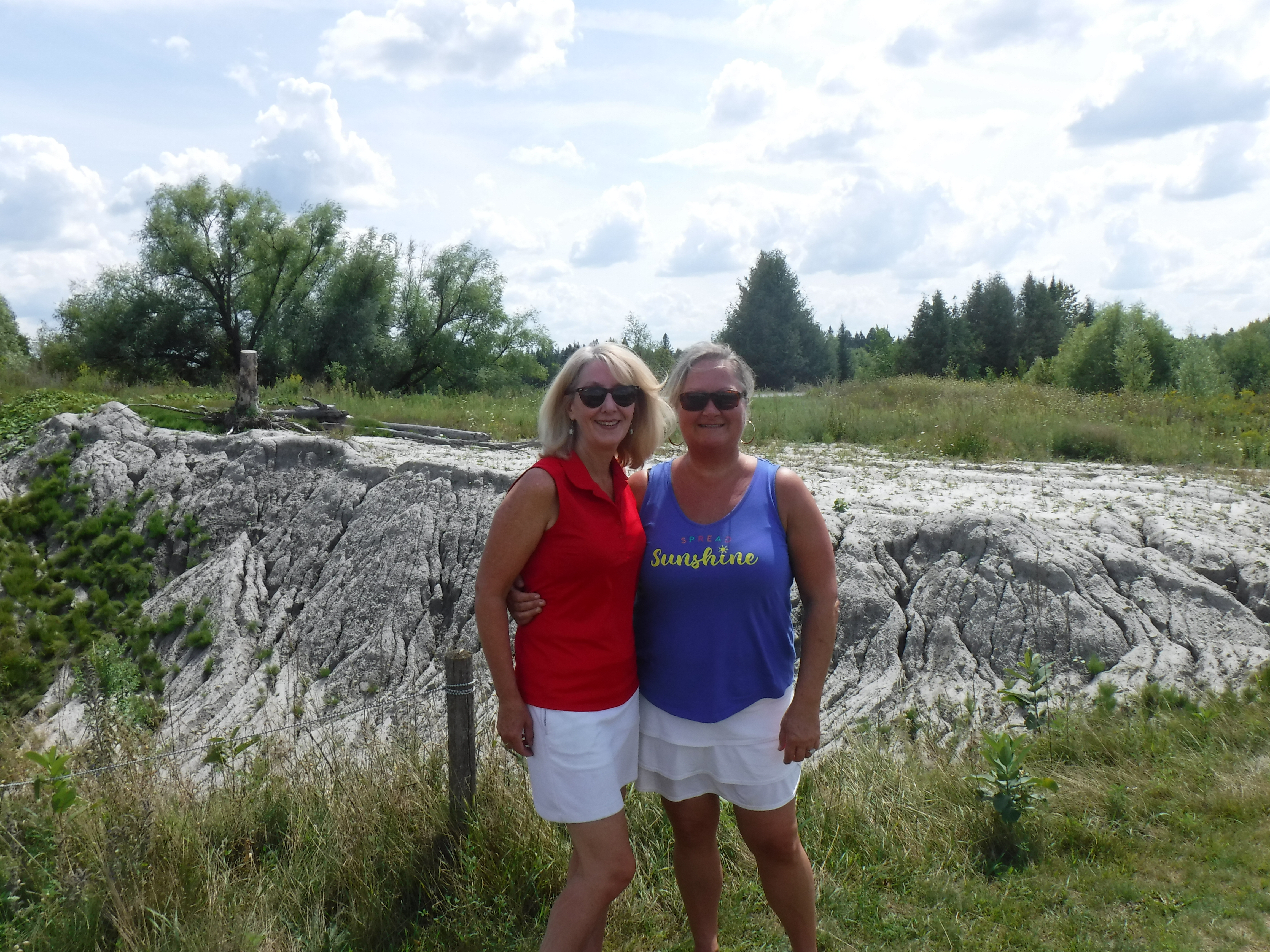 Two women standing together smiling on golf course