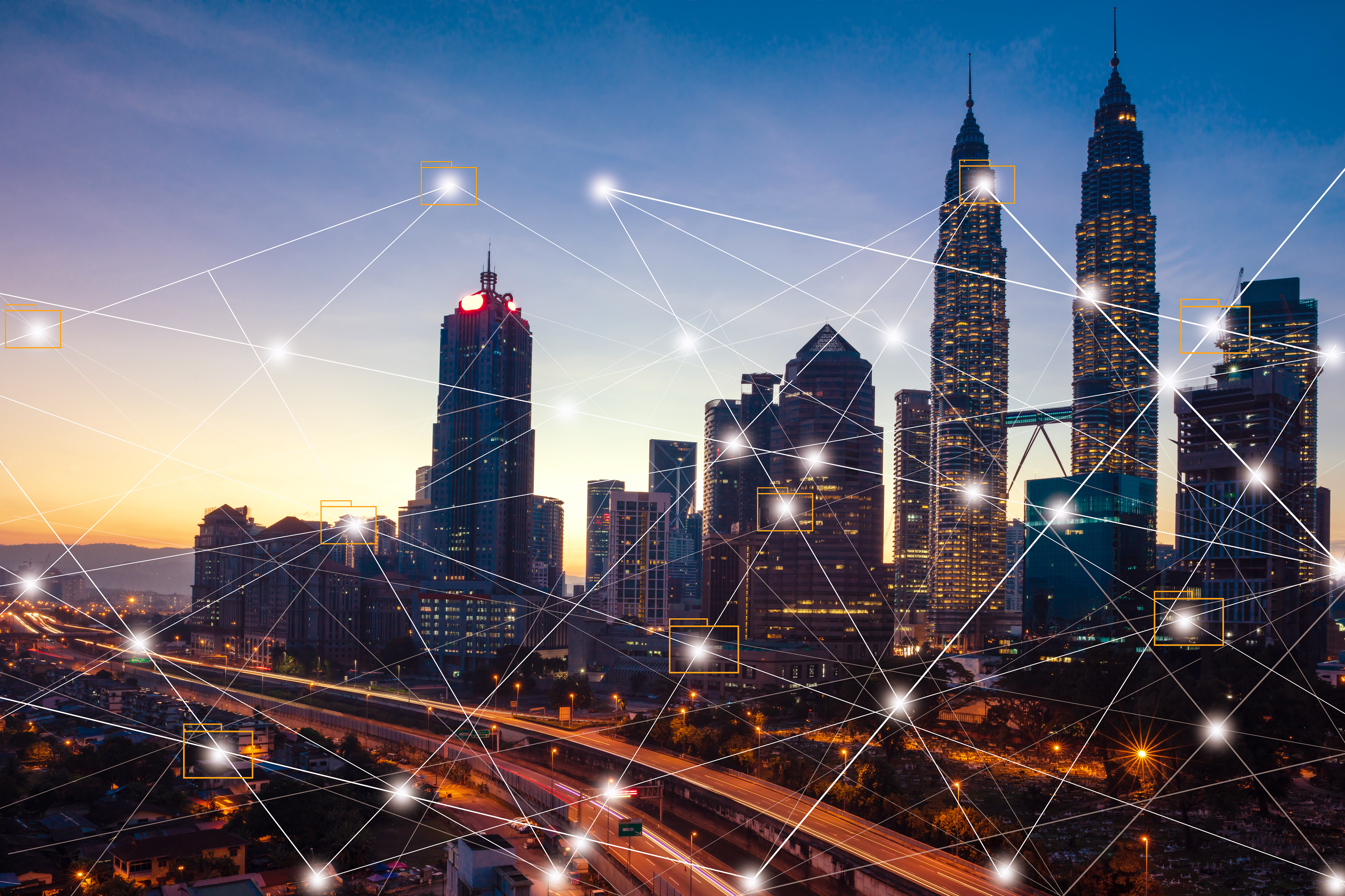 A modern city skyline at dusk illuminated by vibrant lights, symbolizing digital connectivity.