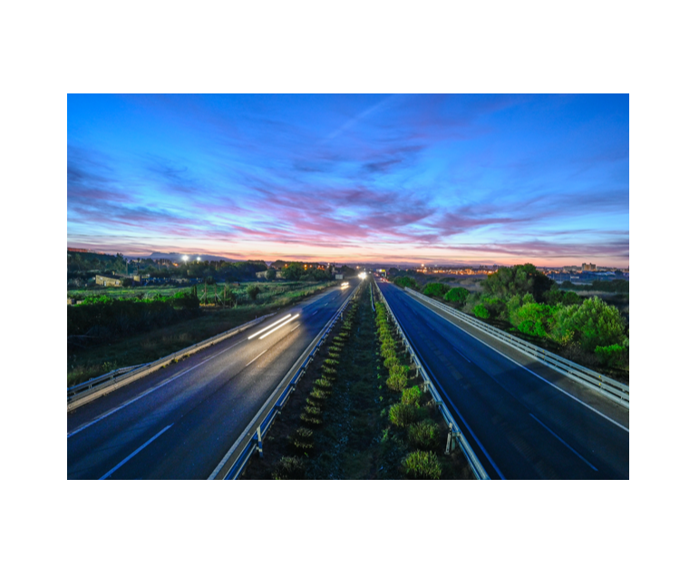 an empty road with during the sunset