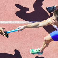 Runner passing baton