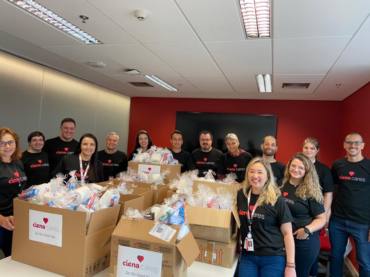 Group of Ciena employees volunteering and wearing black Ciena Cares t-shirts