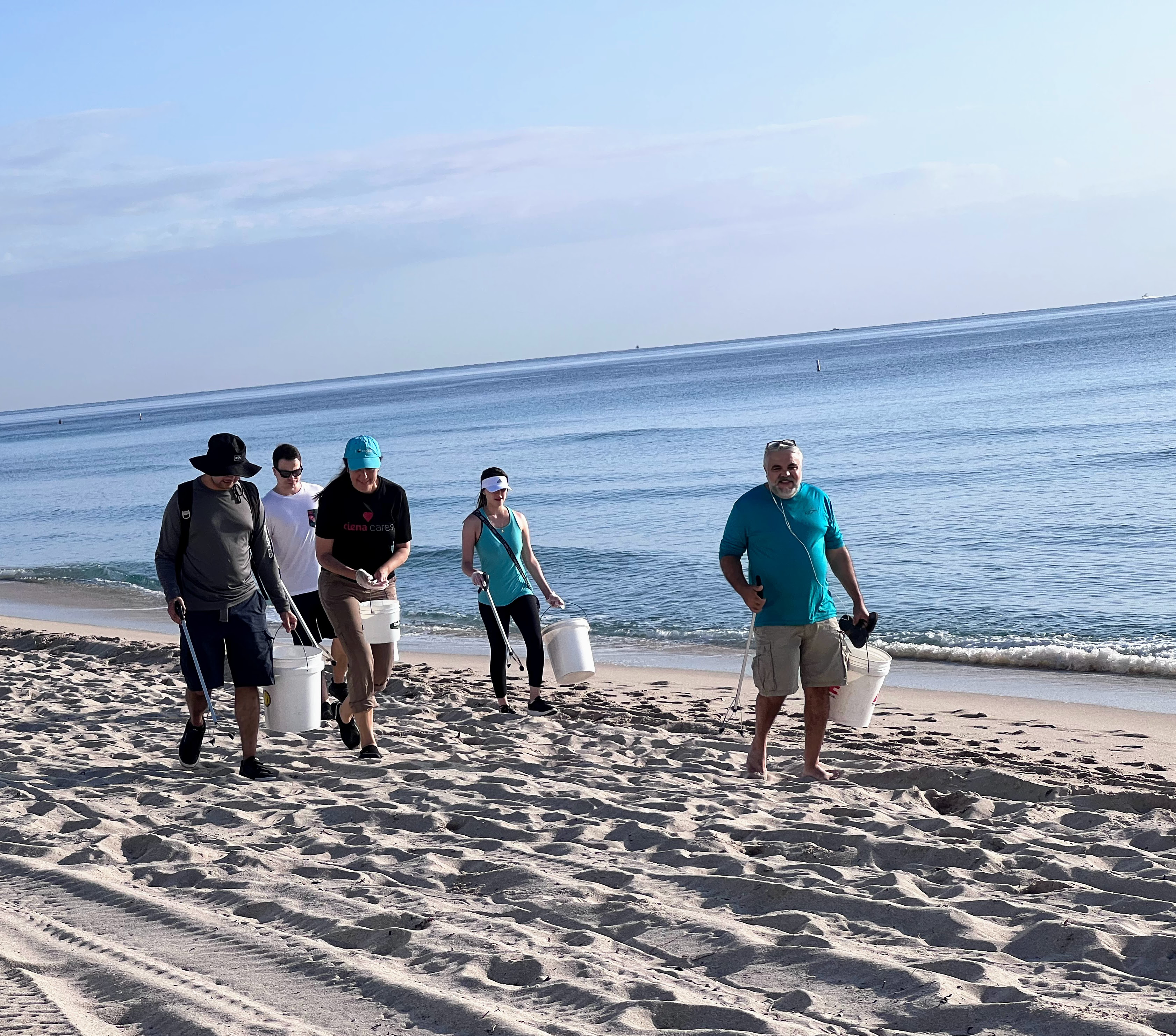 ciena employees cleaning a beach in Miramar florida