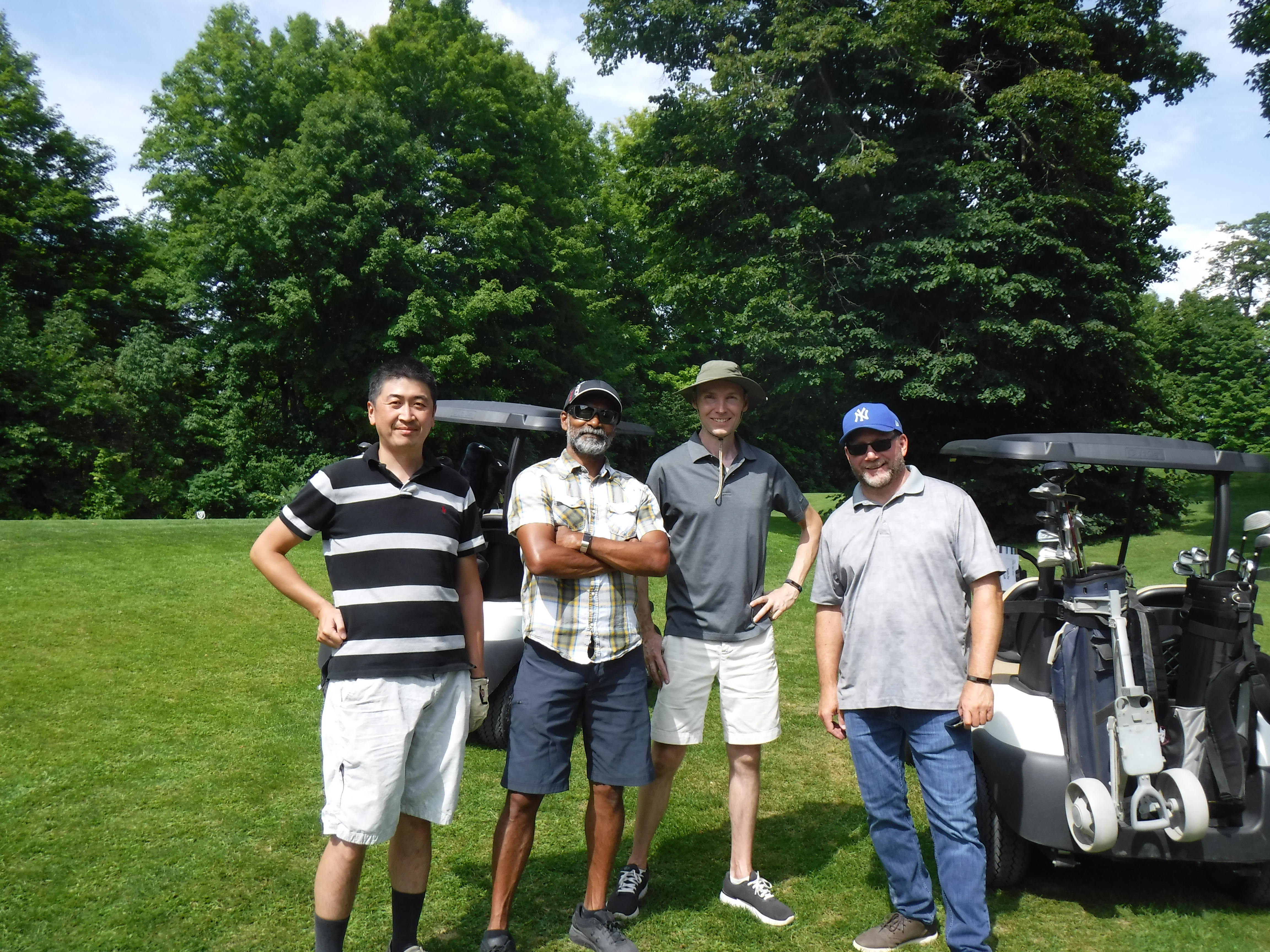 Group of men smiling together on golf course