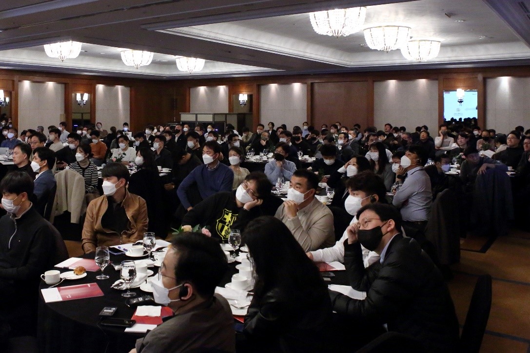 people sitting at tables in a conference room