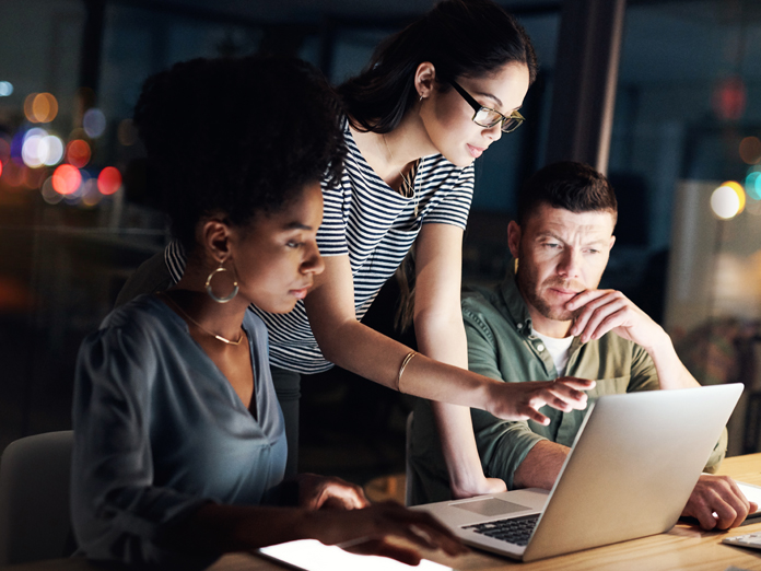 Professionals collaborating through a cloud-hosted network management platform to monitor services, optimize optical networking performance, and improve operational efficiency.